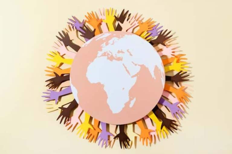 Diverse hands encircling Earth symbolizing global unity