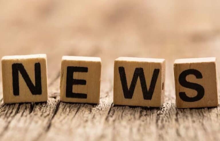 Wooden letter blocks spelling NEWS on table