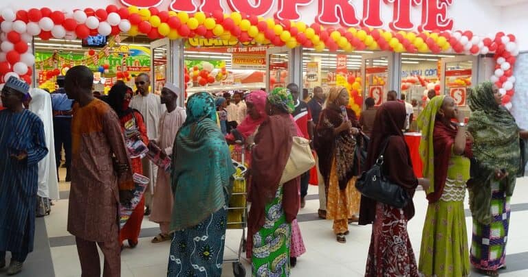 Crowd at balloon-decorated supermarket grand opening