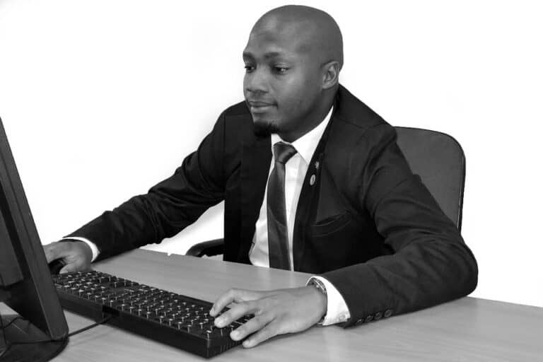 Businessman in suit working at desktop computer