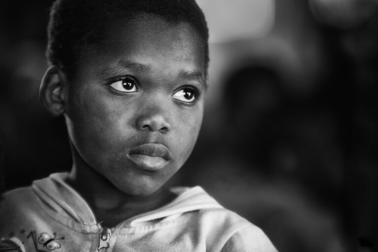 Young child in black-and-white portrait looking aside