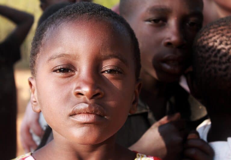 Close-up of child with other children behind