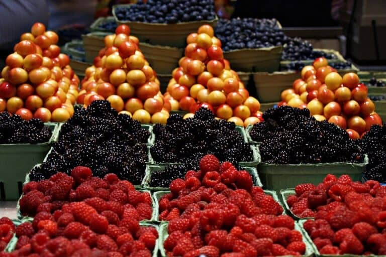 Fresh berries and tomatoes at market stand