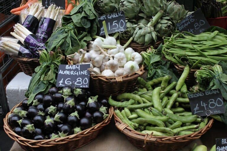 Market stall with fresh vegetables in wicker baskets
