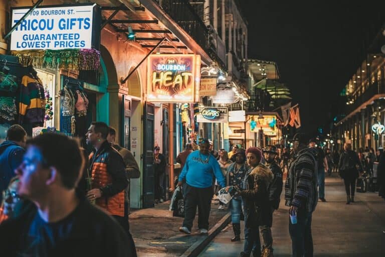 Crowded Bourbon Street at night with neon signs