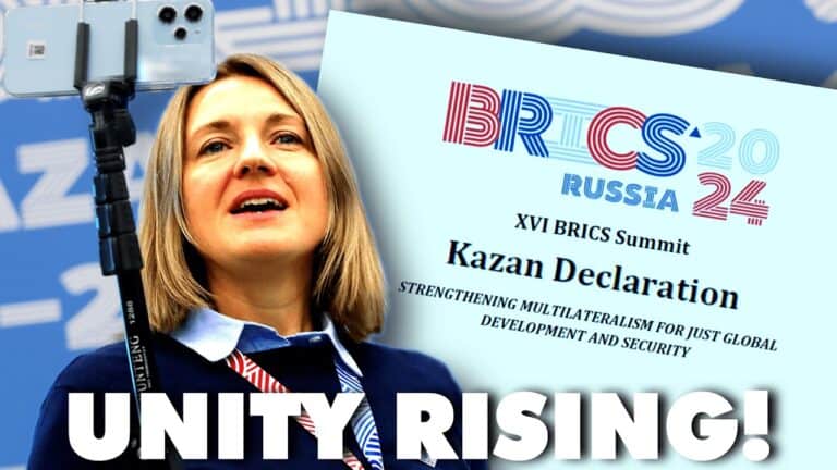 Woman speaking beside BRICS 2024 Kazan Declaration poster