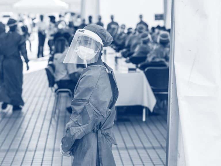 Healthcare worker wearing mask and face shield in clinic