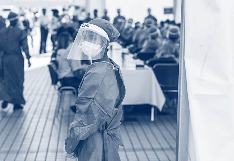 Healthcare worker wearing mask and face shield in clinic
